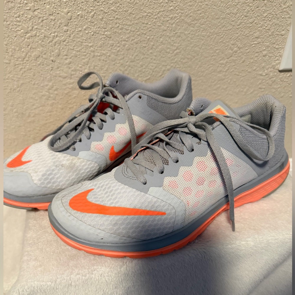 Ladies size 9 Nike Light Gray and Bright Orange Sneakers